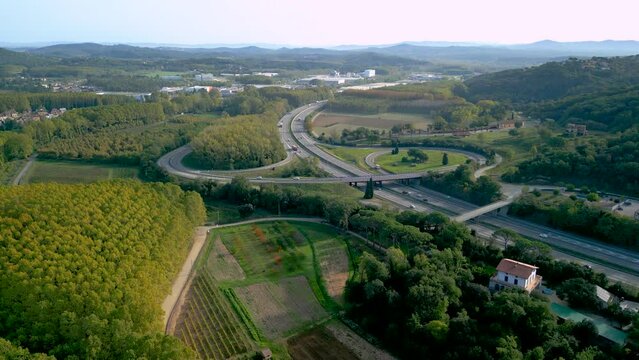 Aerial image of the motorway road C32 Barcelona France, flowing traffic of cars lush green vegetation