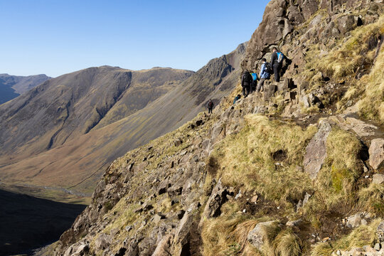 Hikers cling to rocky edge on Corridor Route down Scafell Pike summit
