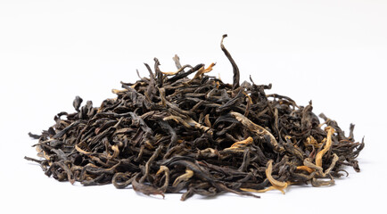 Pile of Yunnan Dianhong black tea dried tea leaves on white background.