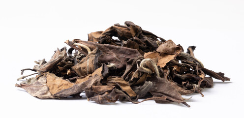 Tea leaves. Pile of old dry white tea leaves on a white background.