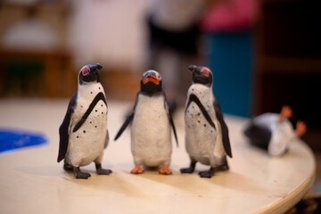 Three toy figurine penguins