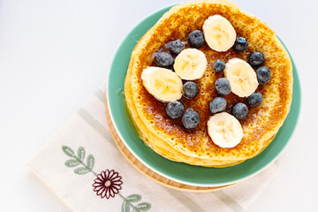 Pancakes with honey and fresh berries and fruits for breakfast