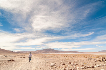 Fototapeta na wymiar Man walking alone in the Bolivian altiplano