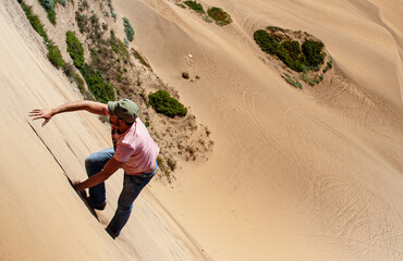 Man climbing a dune in the desert
