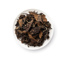 Tea leaves. Pile of old dried white tea leaves in a white china plate.