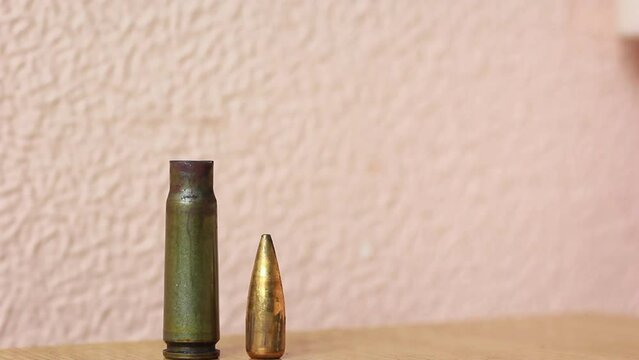 Male hand arranges bullets and cartridge cases close-up