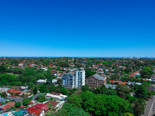 Fototapeta premium Panoramic Aerial Drone view of Suburban Sydney housing, roof tops, the streets and the parks