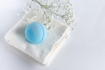Blue bath bombs on towel on white background. Beauty spa, aroma cosmetic composition..