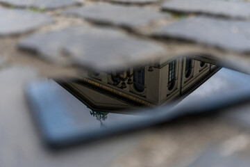 reflection of a building in a smartphone glass