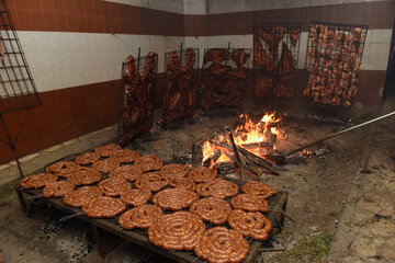 Barbecue, sausage and cow ribs, traditional argentine cuisine, Patagonia, Argentina.