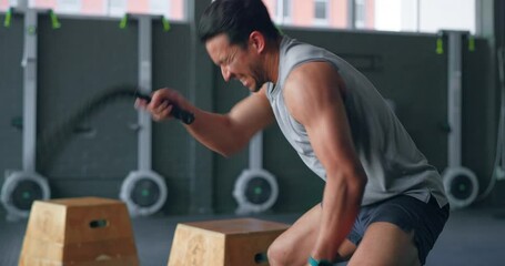 Exercise, rope workout and a man in gym training and building muscle strength. Balance, motivation and fitness, high energy performance bodybuilder with power, wellness and strong healthy lifestyle. - Powered by Adobe