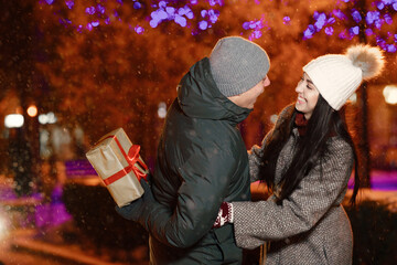 Young couple outdoor in night street at winter time