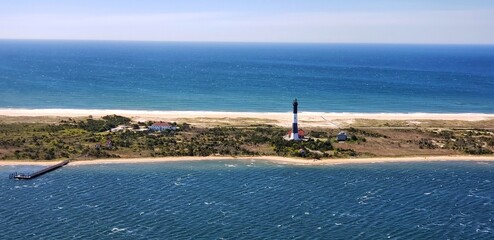 The Fire Island Lighthouse is a visible landmark on the Great South Bay, in southern Suffolk County, New York on the western end of Fire Island, a barrier island off the coast of Long Island © ss