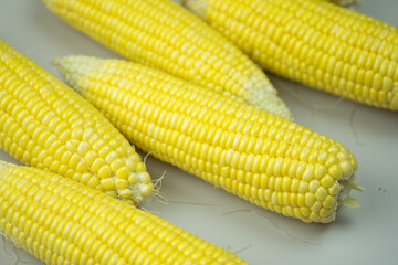 Fresh, yellow cobs of appetizing corn. Organic food, healthy lifestyle.