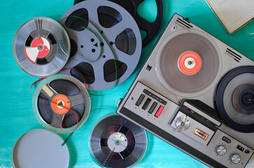 Vintage audio reel to reel tape recorder and magnetic recording tapes, flat lay
