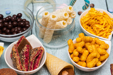 Salty and sweet snacks. Table of salty and sweet snacks. Large group of unhealthy food