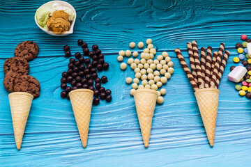 Ice cream cones with colorful candies, cookies, and chocolate balls
