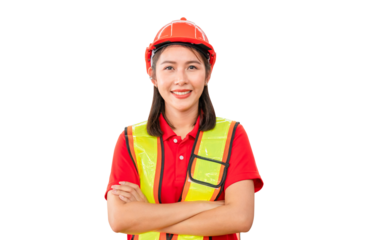 Young female warehouse worker standing in warehouse with arms crossed, Smiling woman in hard hat looking at camera with arms crossed