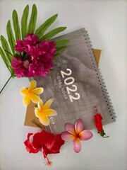 Calendar and flowers on white background 