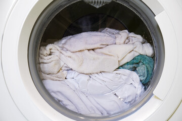 Modern washing machine, Clothes washing machine in laundry, Laundry being done at home