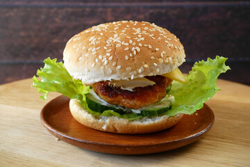 one tasty burgers with meat  burger on plane on wooden background