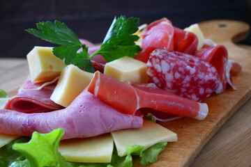 Cold Smoked Meat, jamon, sausage, cold meat, cheese. Plate, antipasto set platter wooden plate. Cold smoked meat plate with sliced ham, prosciutto, bacon.