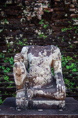 an old headless sculpture in a temple complex in vietnam