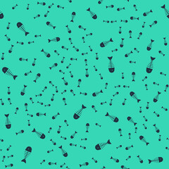 Black Fish skeleton icon isolated seamless pattern on green background. Fish bone sign. Vector