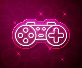 Glowing neon line Gamepad icon isolated on red background. Game controller. Vector