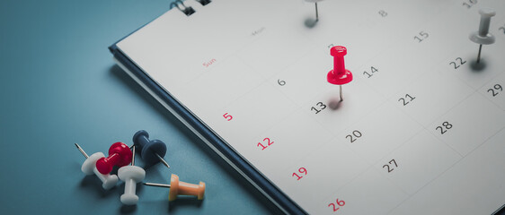 Embroidered red pins on a calendar event Planner calendar,clock to set timetable organize...