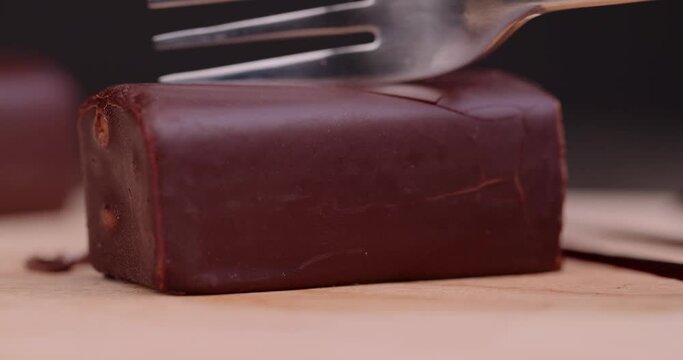Divide with a fork sweet curd cheese from milk with milk chocolate, sweet dessert from dairy products and chocolate