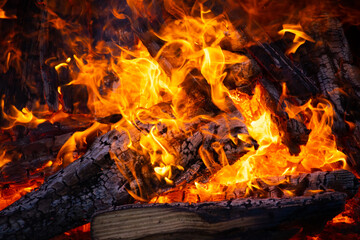 A bonfire of firewood in close-up. Red-hot coals in the fire. Heating of the house.