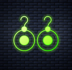 Glowing neon Earrings icon isolated on brick wall background. Jewelry accessories. Vector