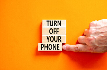 Turn off your phone symbol. Concept words Turn off your phone on wooden blocks. Beautiful orange...