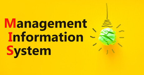 MIS management information system symbol. Concept words MIS management information system on a beautiful yellow background. Light bulb. Business MIS management information system concept. Copy space © Dzmitry