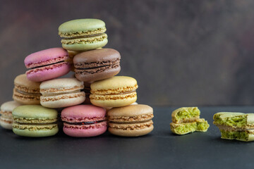 stack of colorful macaroons, close up, one macaron in two halves