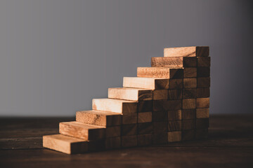 Wooden block stacked concept of prevent collapse or crash of financial business and risk management...