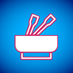 White Asian noodles in bowl and chopsticks icon isolated on blue background. Street fast food. Korean, Japanese, Chinese food. Vector