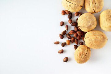 walnuts and pine nuts on a white background, copy space, supermarket products