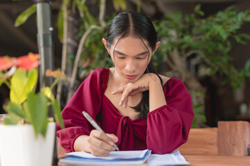 A hardworking transgender woman prepares for her exam as she studies her reading materials at an...