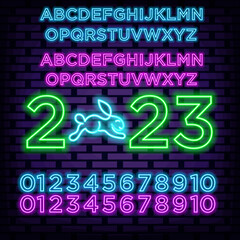 2023 Happy New Year and Merry Christmas alphabet Neon quote. On brick wall background. Light banner. Bright colored vector. Vector Illustration
