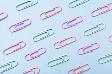 Multiple paperclip, flat lay group of objects on blue background