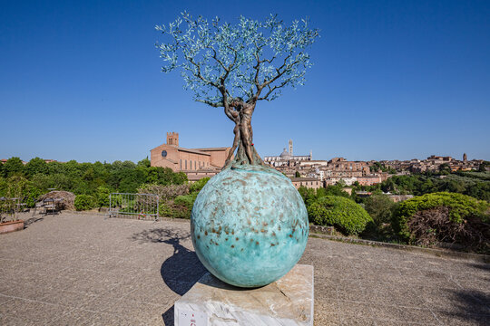 SIENA, ITALY - May, 2022: cityscape. View of sculpture "Terra Mater. Earth and Heaven" by Andrea Roggi in Siena, Italy.