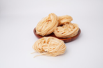 Yellow noodles flour raw materials for cooking on a white background