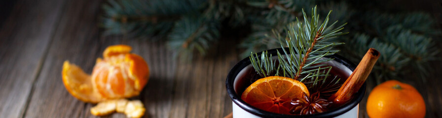 banner of Traditional tasty mulled wine hot drink with mandarin apple spices and christmas tree in...