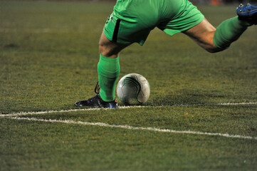 Professional football or soccer player in action on stadium