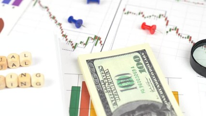 Business concept. Moving the camera from dollars to cubes with the inscription - Annual meeting - Powered by Adobe