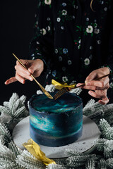 Obraz premium a woman cuts a sweet birthday cake for food