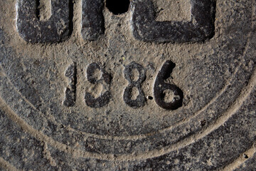 Photo of a fragment of a sewer manhole with the designation of the year in the Georgian city of...
