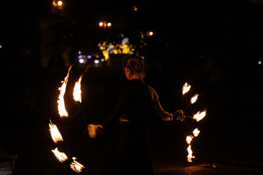 woman with torches on a fire show at night